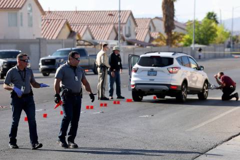 Las Vegas police investigate at the scene of a collision involving a bicycle and vehicle in the ...