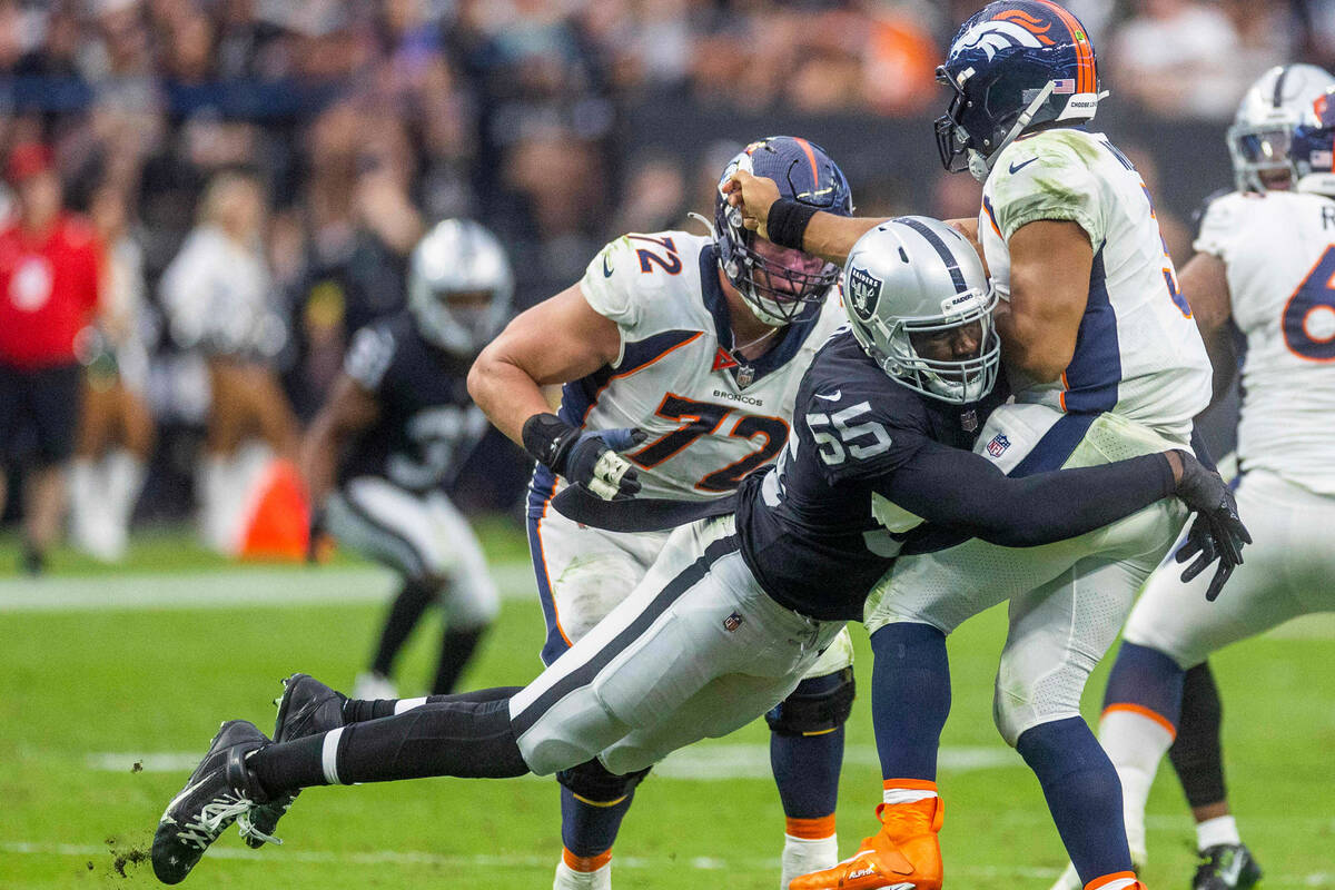 Raiders defensive end Chandler Jones (55) crashes into Denver Broncos quarterback Russell Wilso ...