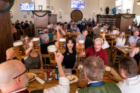 Guests raise their beer mugs for a cheers during the grand reopening of Hofbrauhaus Las Vegas o ...
