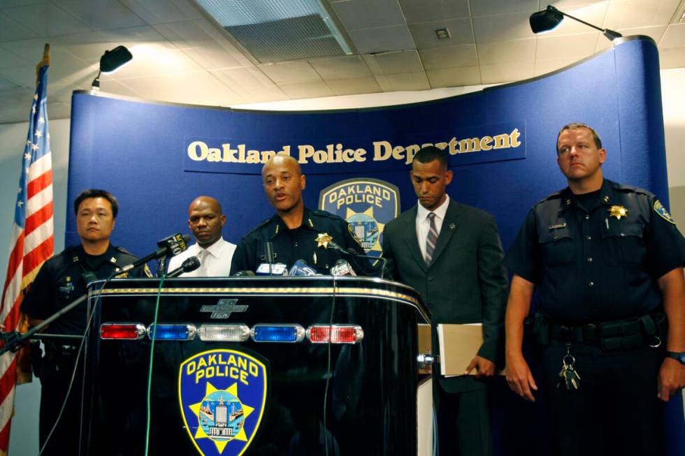 Oakland Assistant Police Chief Howard Jordan, center, takes questions from the media during a n ...