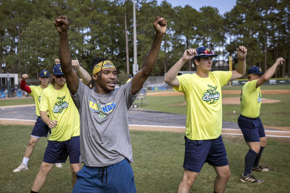 Savannah Bananas first base coach Maceo Harrison, foreground, teaches a dance routine to member ...