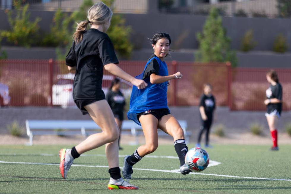 Kylie Roberts, right, kicks the ball for a score during a girl team soccer practice at Doral Ac ...