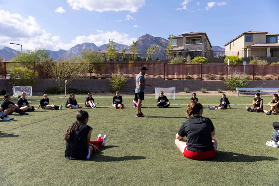 Soccer coach Kurt Divich talks to his players during a girls team practice at Doral Academy Red ...