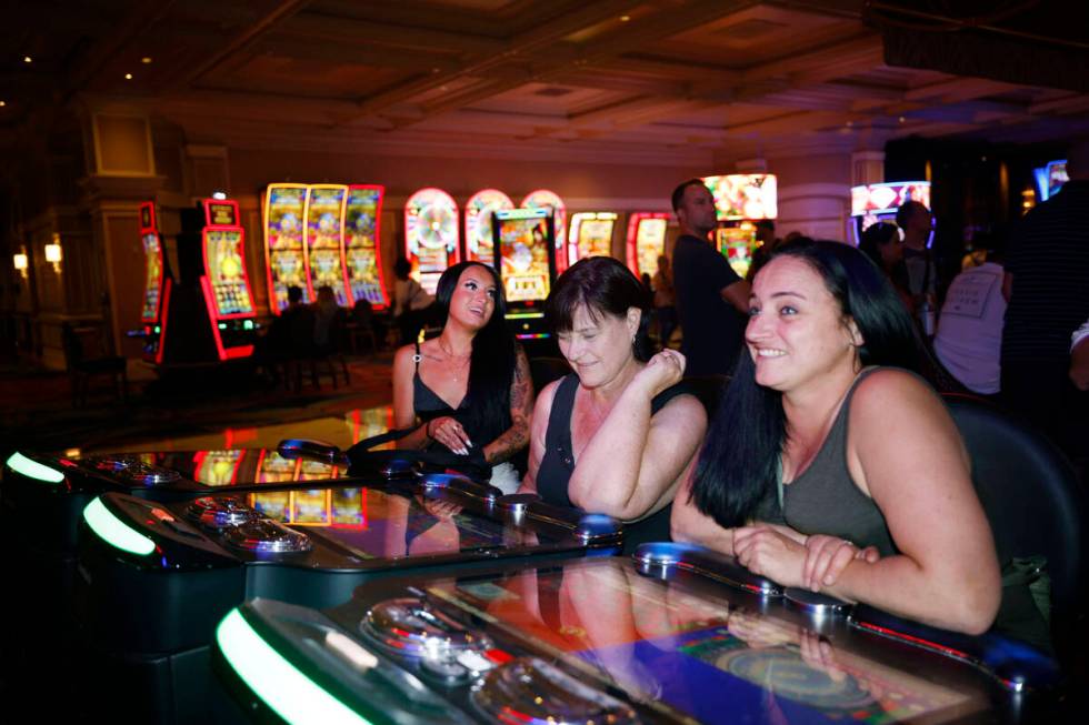 Stacey McLachlan, right, of Vancouver plays an electronic table game at the Bellagio, Thursday, ...