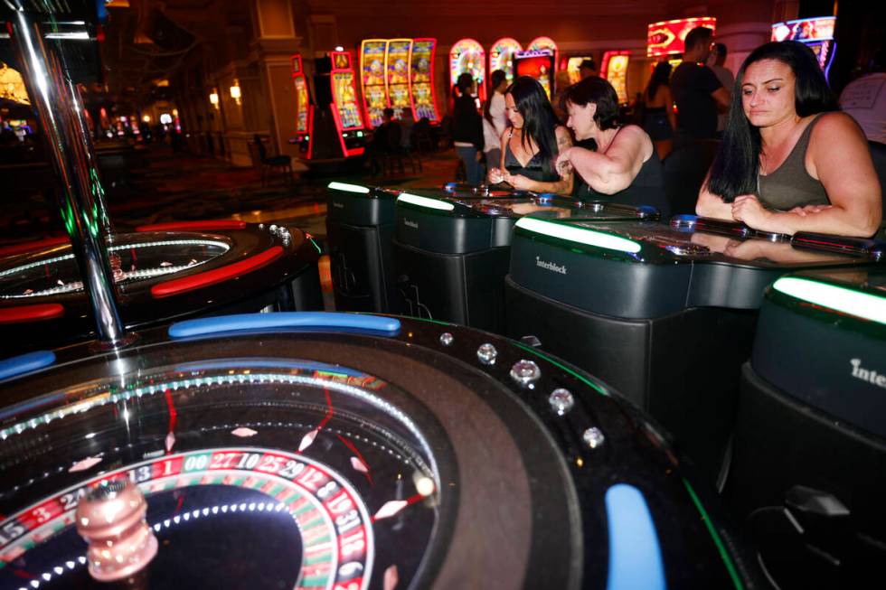 Stacey McLachlan, right, of Vancouver plays an electronic table game at the Bellagio, Thursday, ...