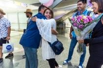 (From left) Scott Hoffman hugs Shabana for the first time after she arrives with husband Mohamm ...