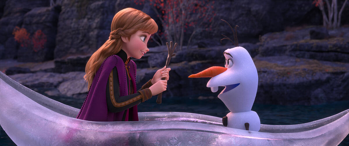 This image released by Disney shows characters Anna, voiced by Kristen Bell, and Olaf, voiced b ...