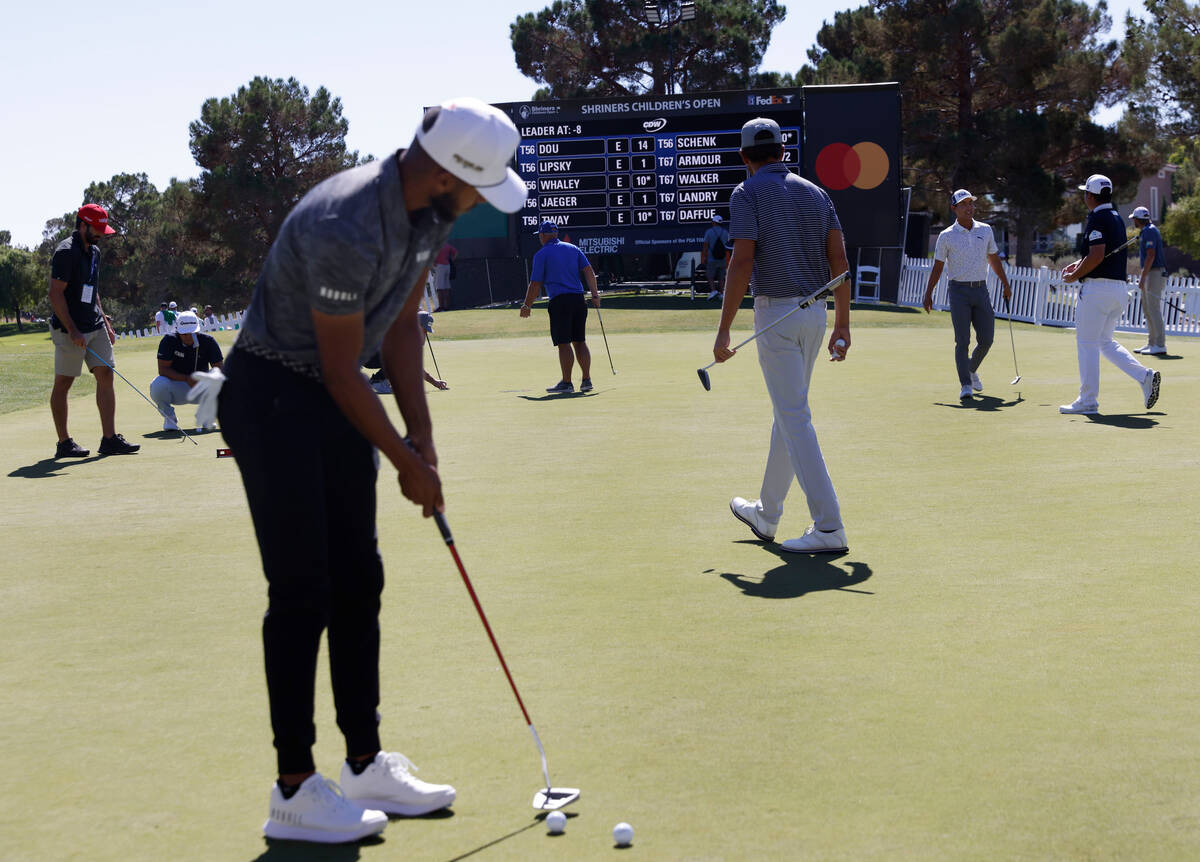 Golfers practice their putts during the first round of the Shriners Children's Open tournament ...