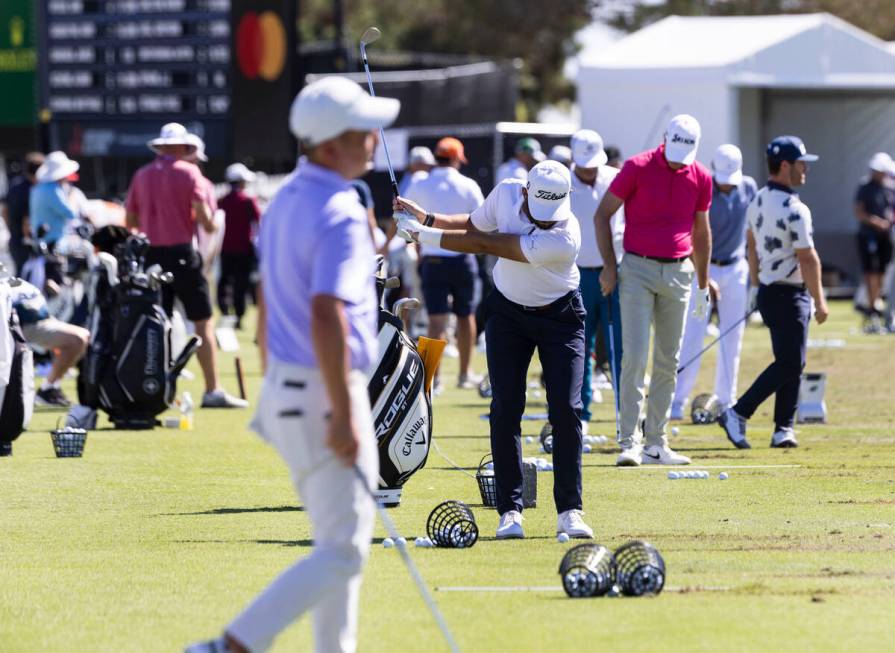 Golfers practice their drive during the first round of the Shriners Children's Open tournament ...