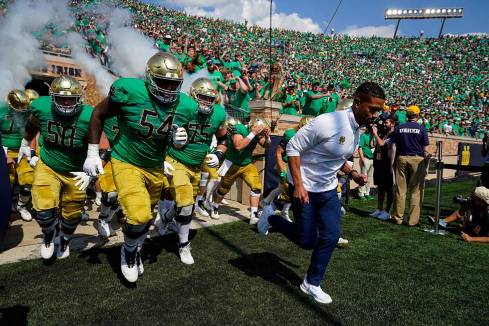 Notre Dame head coach Marcus Freeman leads his team through the tunnel and to the field before ...