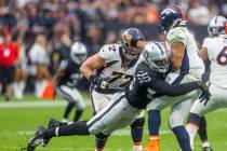 Raiders defensive end Chandler Jones (55) crashes into Denver Broncos quarterback Russell Wilso ...