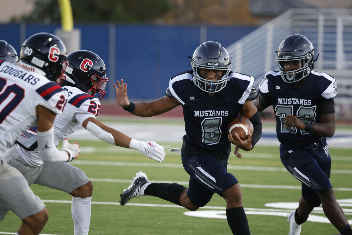 Shadow Ridge’s Coen Nicholas Coloma (8) carries the ball against Coronado’s Prest ...