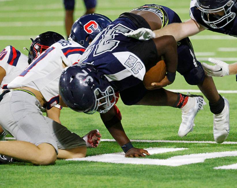 Shadow Ridge’s Jon Wilson (32) is tackled by Coronado’s Roderick Edwards, left, a ...