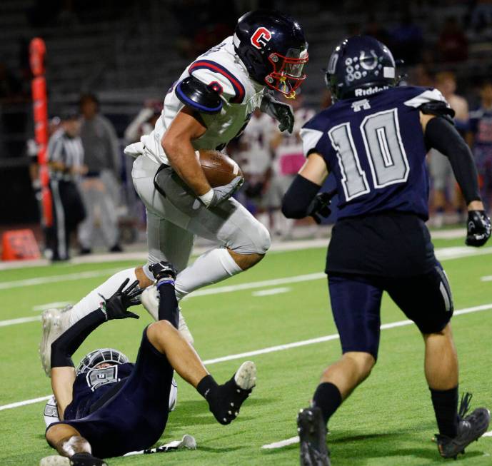 Coronado’s Michael Floyde (8) jumps over Shadow Ridge’s Jonah Ruiz, bottom, as Sh ...