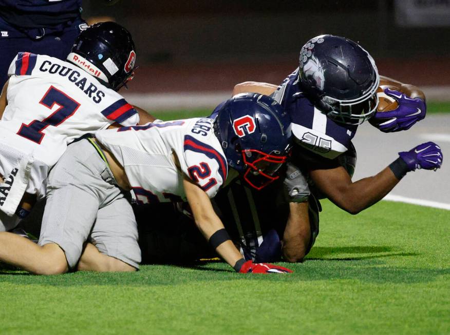 Shadow Ridge’s JaQuieze Holland is tackled by Coronado’s Roderick Edwards (21) an ...