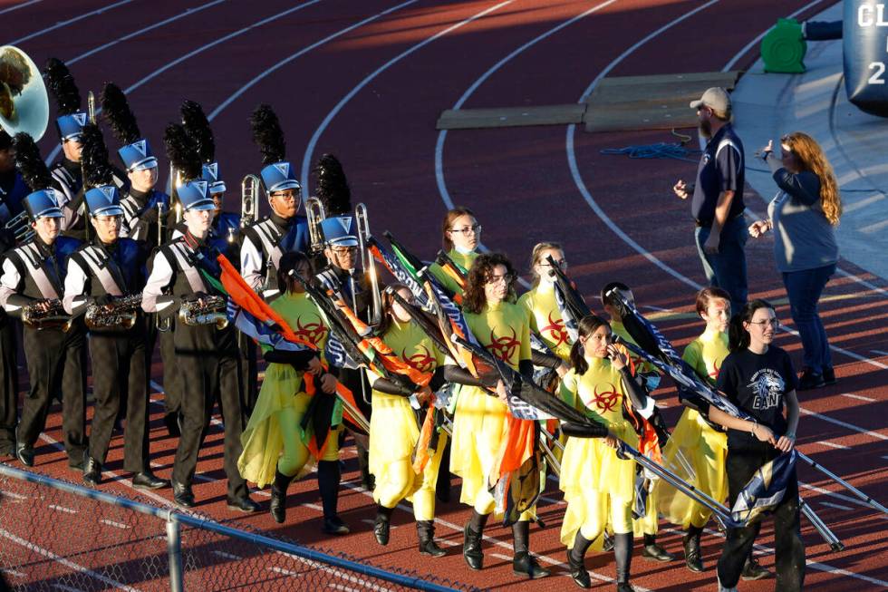 Shadow Ridge High School marching band members perform before a football game against Coronado, ...