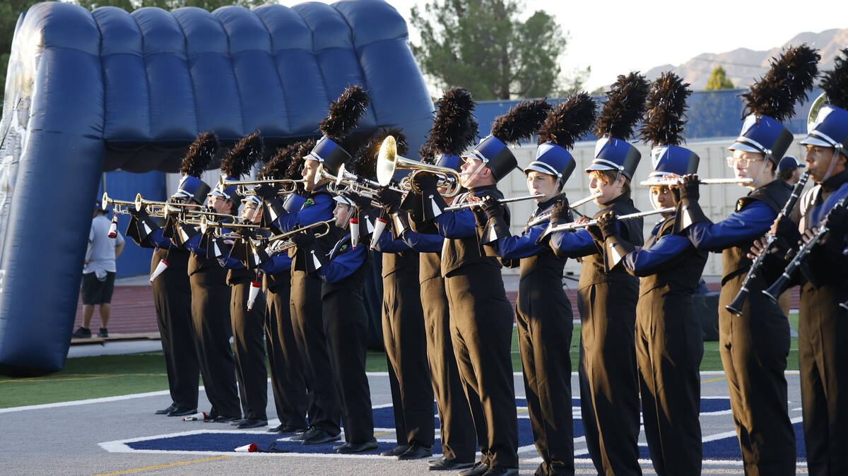 Shadow Ridge High School marching band members perform before a football game against Coronado, ...