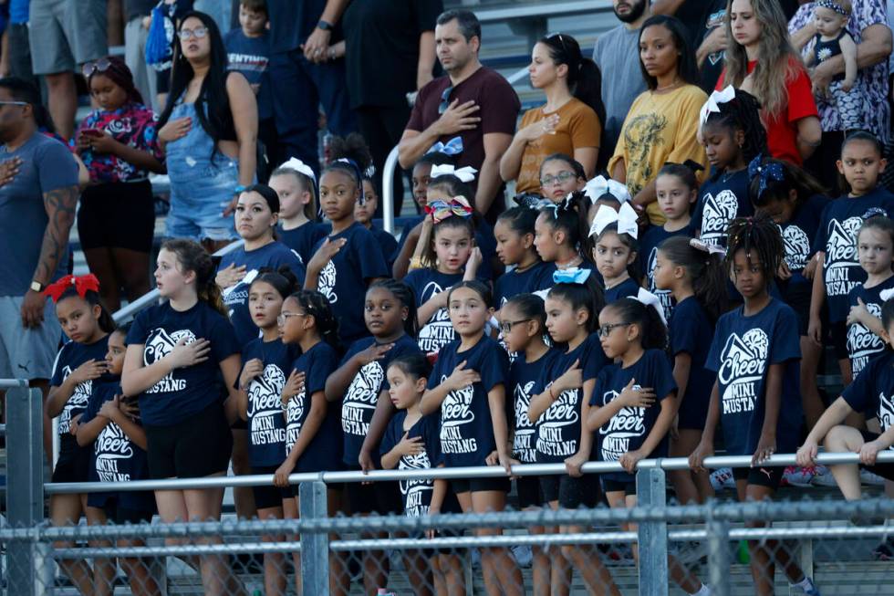 Shadow Ridge High School fans are seen during the national anthem before a football game agains ...