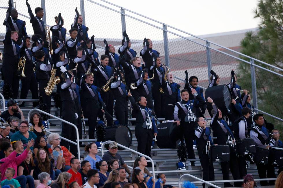Shadow Ridge High School marching band members perform during the first half of a football game ...