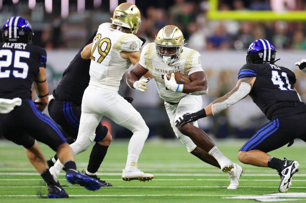 Notre Dame Fighting Irish running back Audric Estime (7) runs the ball against Brigham Young Co ...