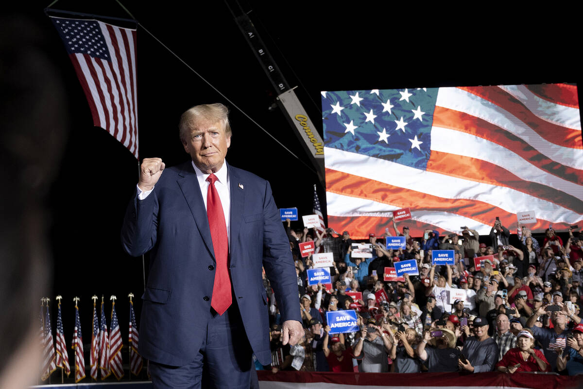 Former President Donald Trump makes his entrance at a rally at the Minden Tahoe Airport in Mind ...