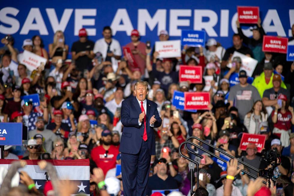 Former President Donald Trump applauds while speaking at a rally at the Minden Tahoe Airport in ...