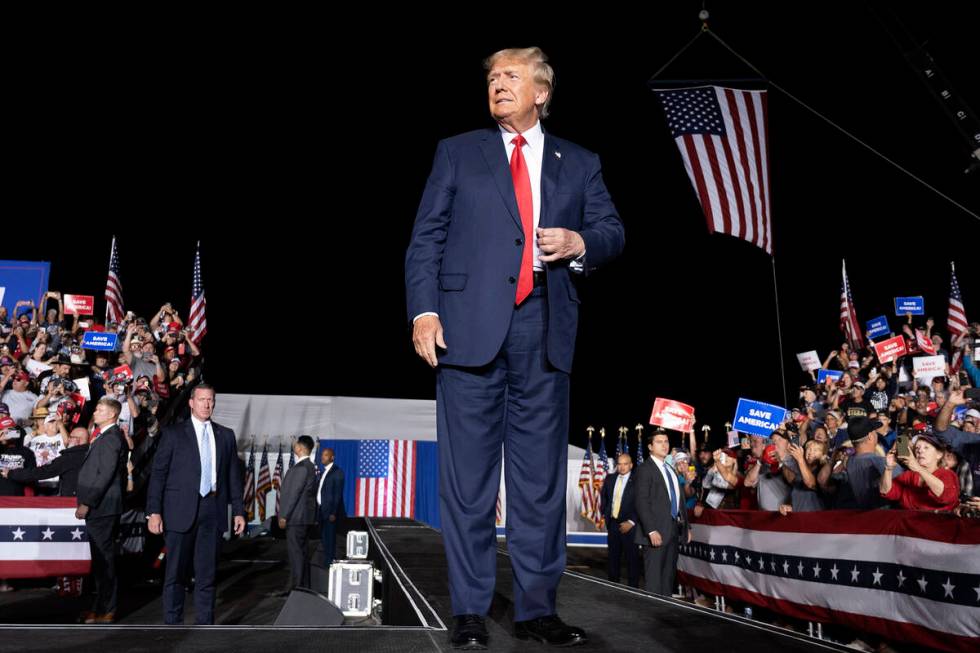 Former President Donald Trump makes his entrance at a rally at the Minden Tahoe Airport in Mind ...