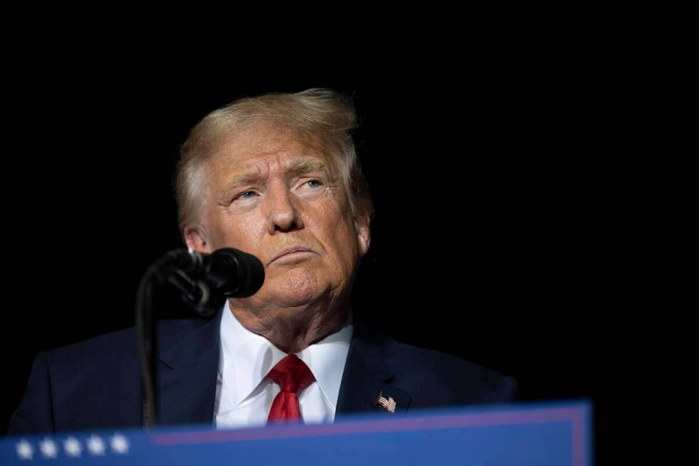 Former President Donald Trump pauses while speaking at a rally at the Minden Tahoe Airport in M ...