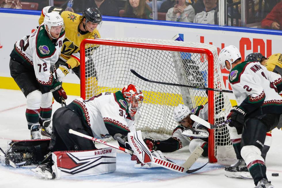 Arizona Coyotes goalie Jon Gilles (32) defends the net while defenseman Shayne Gostisbehere (14 ...