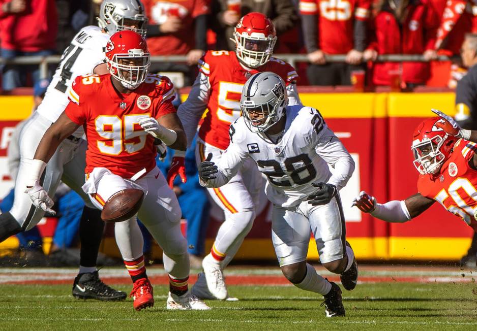 Raiders running back Josh Jacobs (28) loses the ball as Kansas City Chiefs defensive end Chris ...