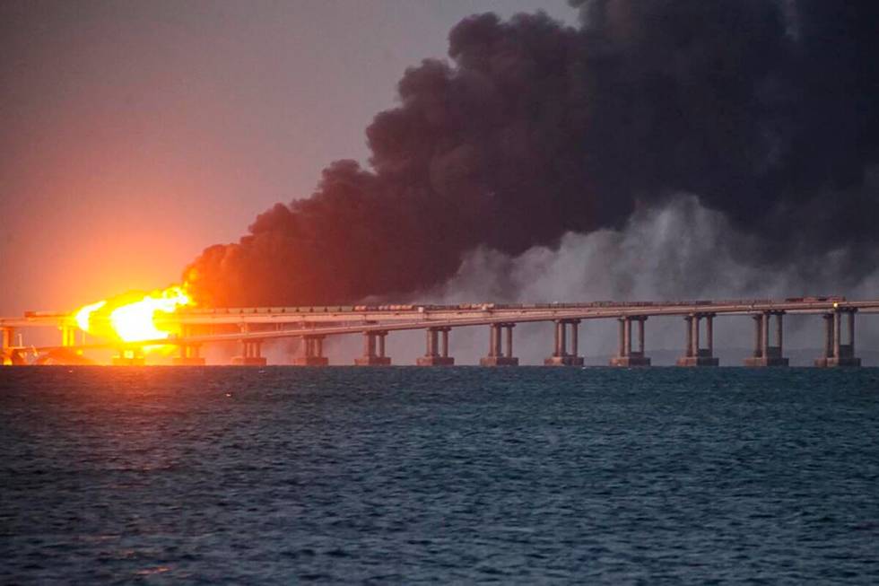 Flame and smoke rise fron Crimean Bridge connecting Russian mainland and Crimean peninsula over ...