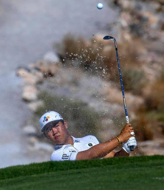 Tom Kim wedges the ball out of a sand trap on the fifth hole during the final day of play in th ...