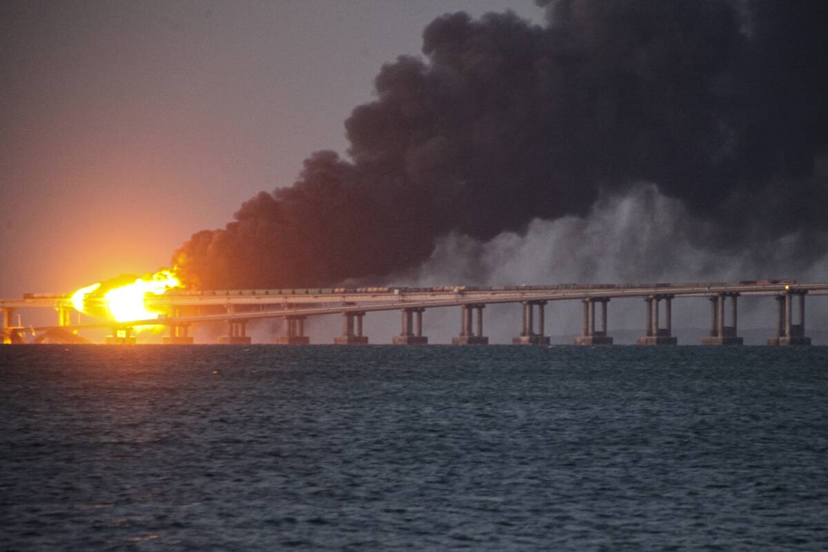 Flame and smoke rise fron Crimean Bridge connecting Russian mainland and Crimean peninsula over ...