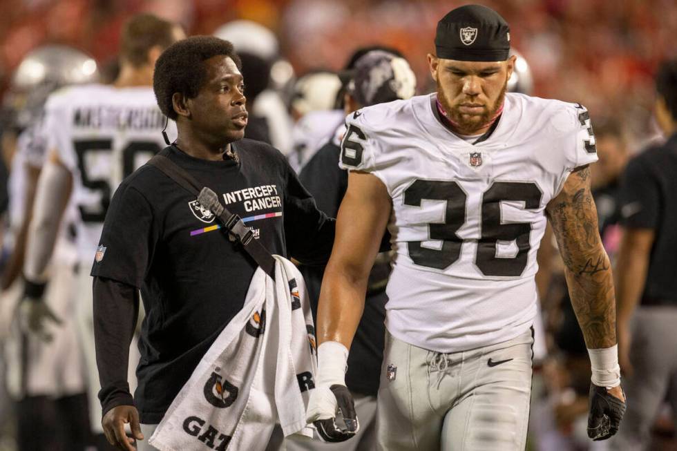 Raiders linebacker Curtis Bolton (36) walks off with a trainer during the second half of an NFL ...