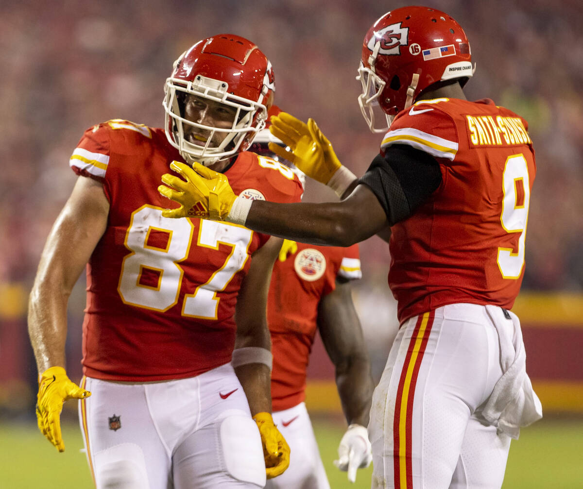 Kansas City Chiefs tight end Travis Kelce (87) is congratulated on his touchdown score by Kansa ...
