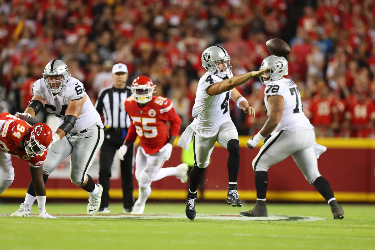 Raiders quarterback Derek Carr (4) makes a pass during the first half of a NFL football game ag ...