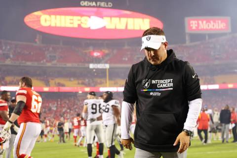 Raiders head coach Josh McDaniels lowers his head as he leaves the field after a 30-29 loss aga ...