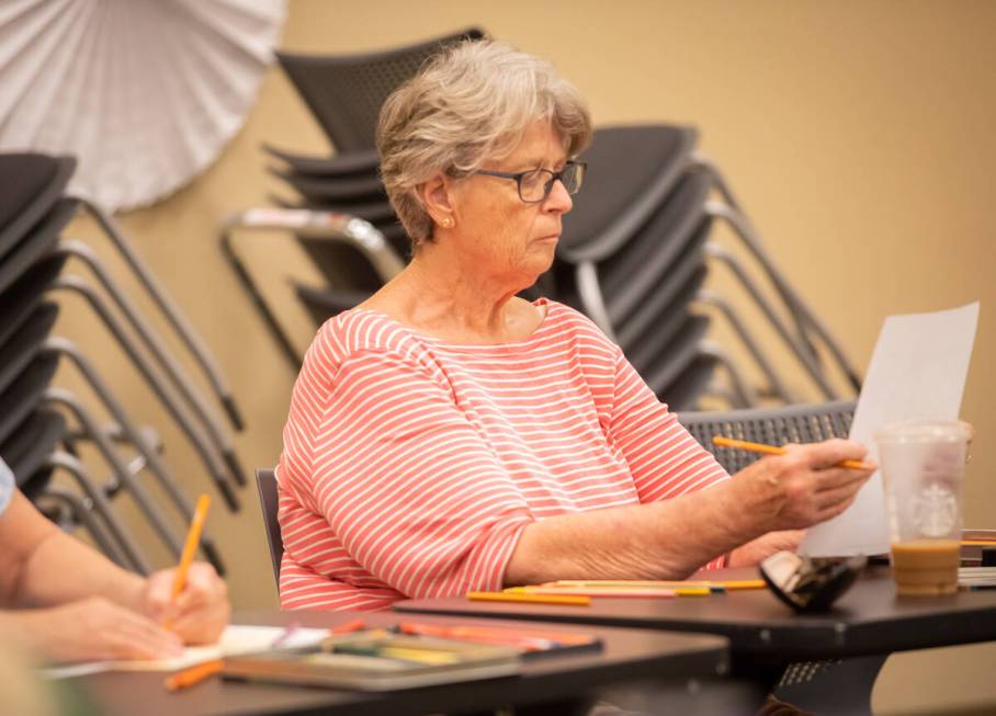 Malinda Henry, 70, checks her coloring page during an Adult Coloring and Journaling session at ...