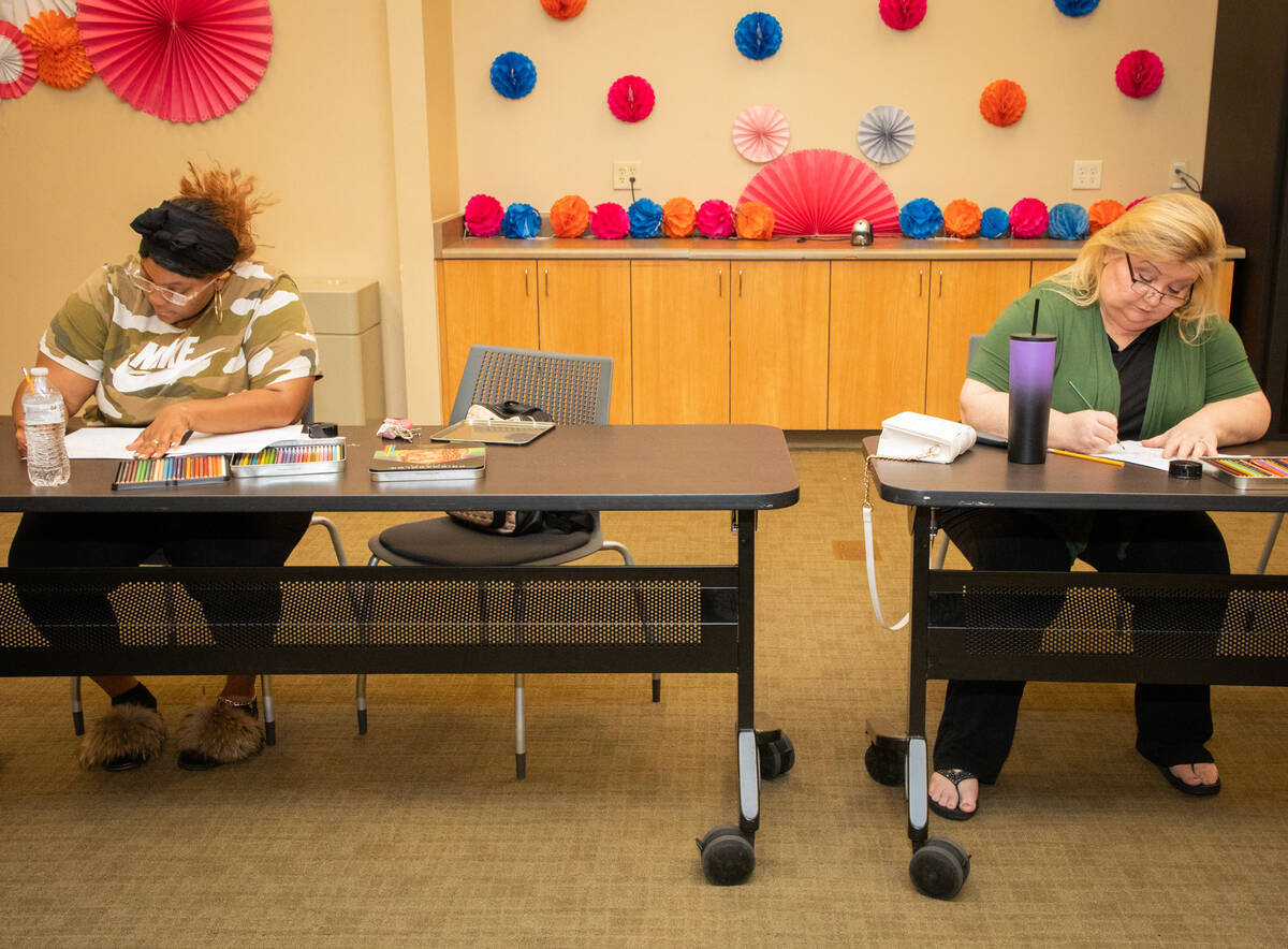 Participants Royneqiuea Fields, left, and Jackie Heier, right, work on coloring activities duri ...