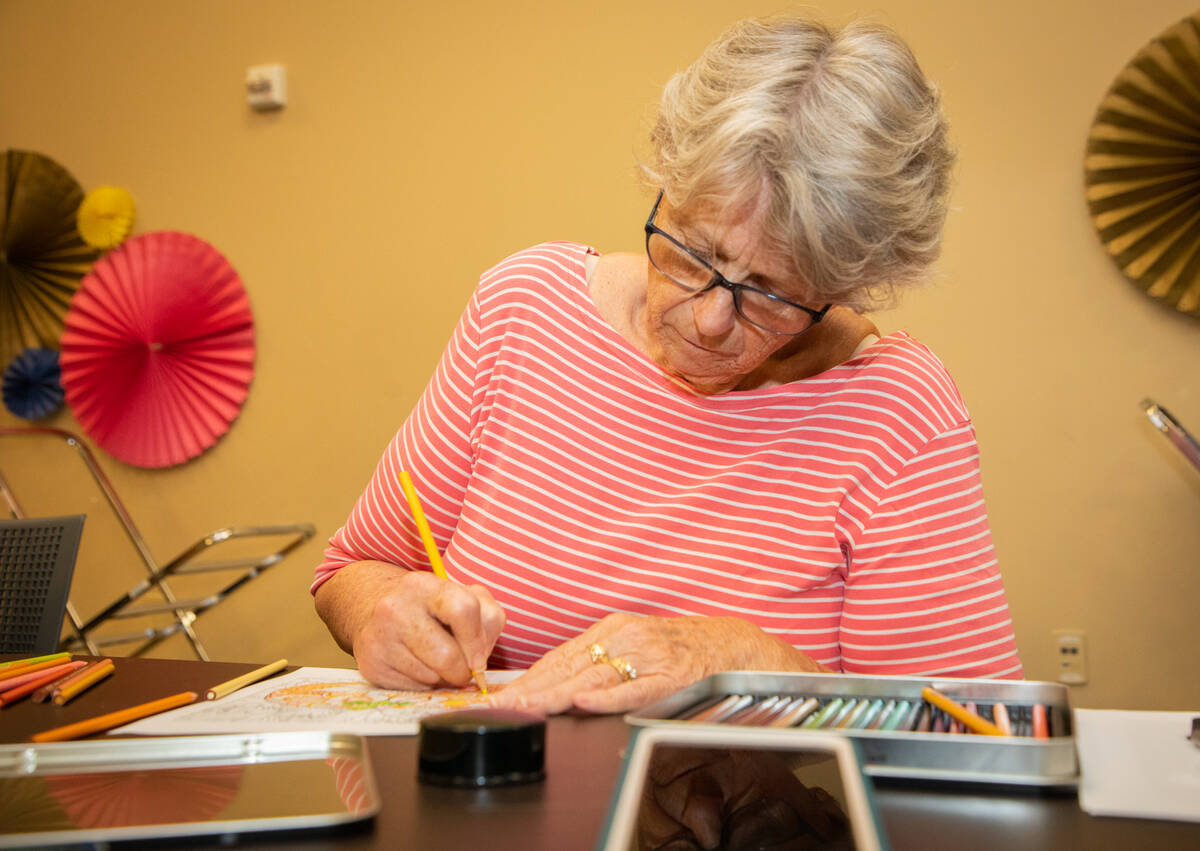 Malinda Henry, 70, colors during an Adult Coloring and Journaling session at the Centennial Hil ...