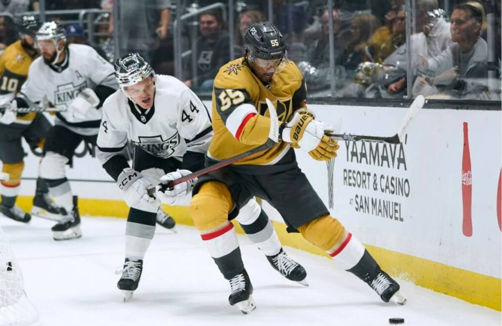 Vegas Golden Knights' Keegan Kolesar, right, is pressured by Los Angeles Kings' Mikey Anderson ...