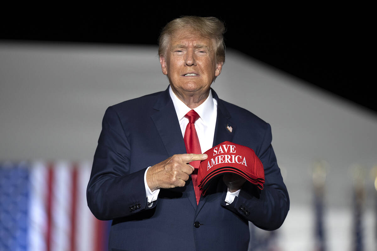 Former President Donald Trump makes his entrance at a rally at the Minden Tahoe Airport in Mind ...