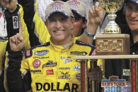 Mark Martin poses with the trophy after winning the NASCAR Sprint Series Kobalt 300 auto race S ...