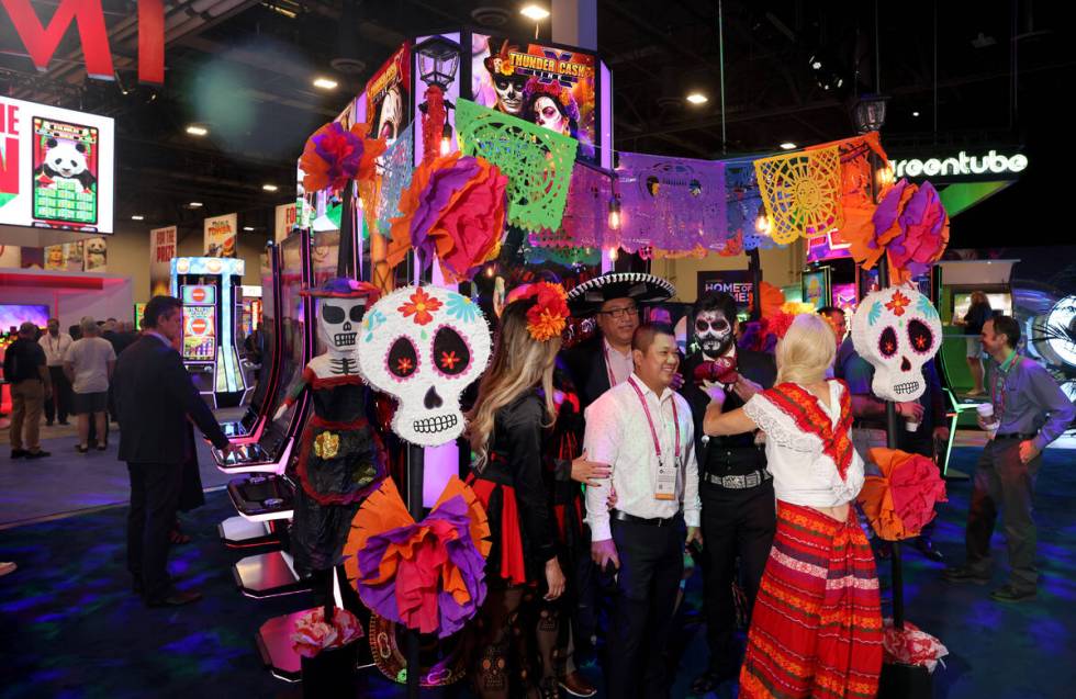 Conentioneers with the Señorita Suerte and Señor Muerte slot machines in the Novomati ...