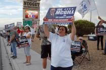 Officers and their supporters hold signs during a rally for Joe McGill on Monday, Oct. 20, 2022 ...