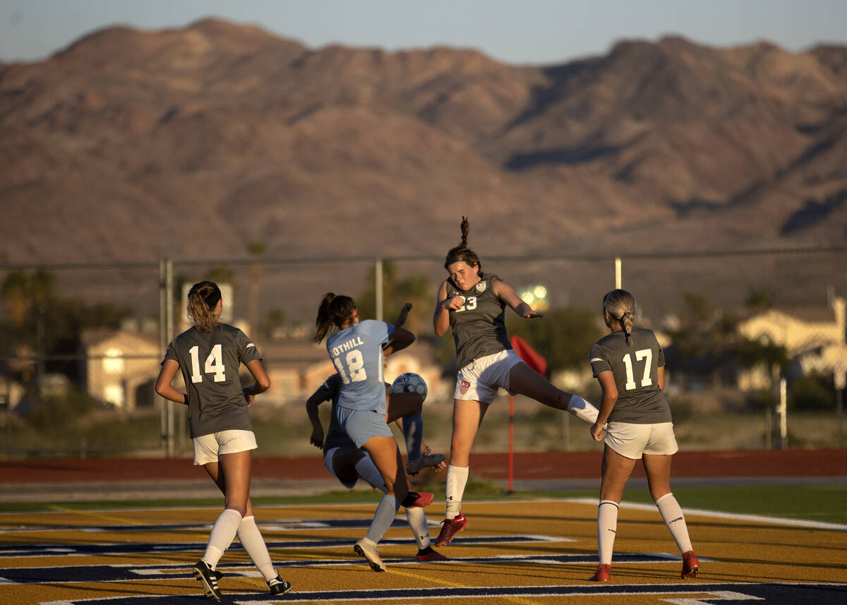 Foothill’s Grace Polster (12) and Sydney Smith (23) collide while jumping to head the ba ...