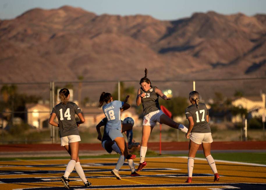 Foothill’s Grace Polster (12) and Sydney Smith (23) collide while jumping to head the ba ...