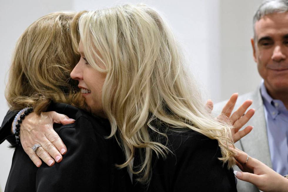 Gena Hoyer hugs Assistant State Attorney Carolyn McCann in court as they await the jury decisio ...