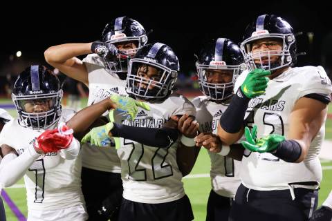 Desert Pines players pose after a 28-10 victory against Green Valley during a football game at ...