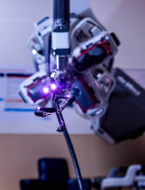 Lights and instruments extend from a patient cart from a da Vinci SP surgical robot in an opera ...